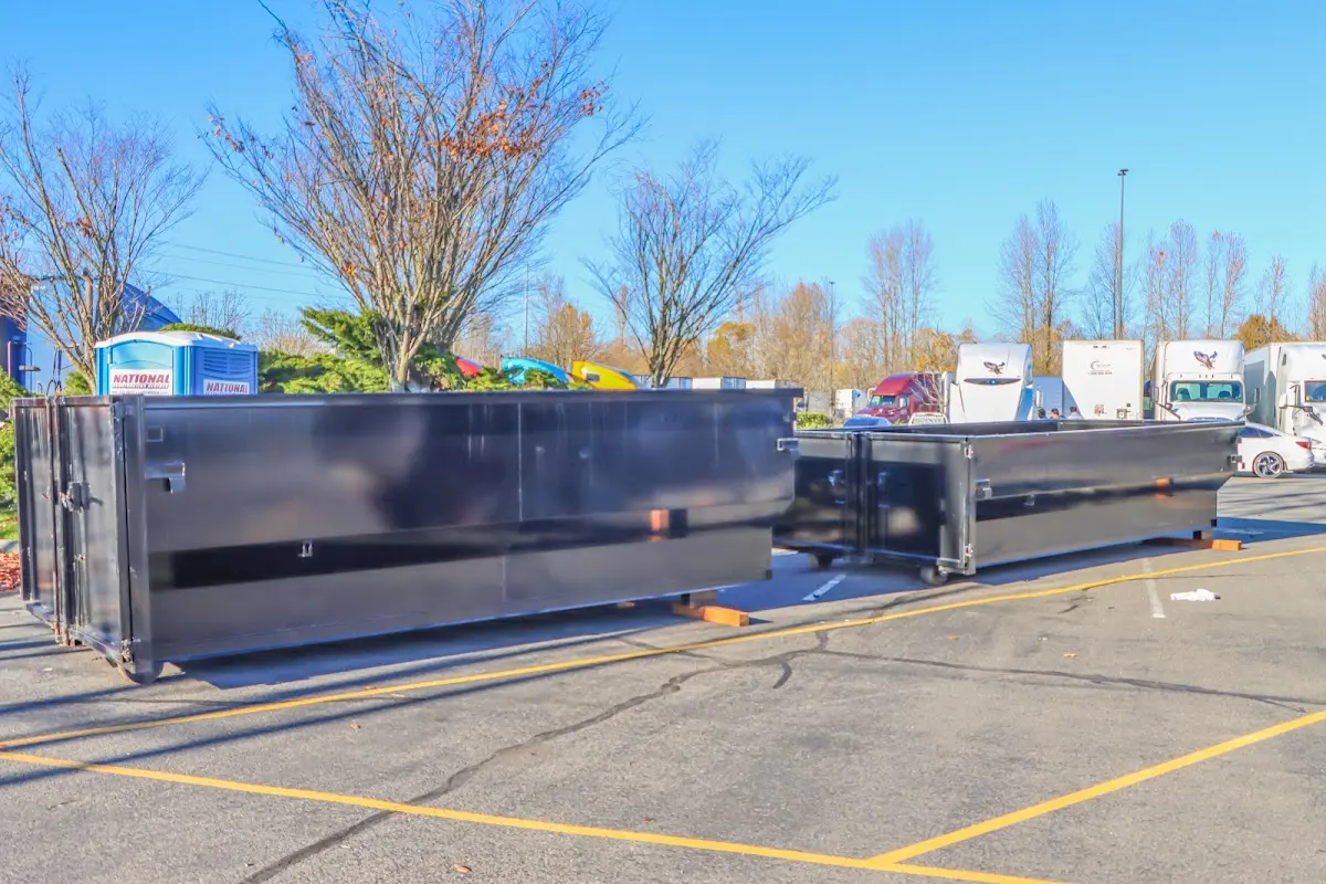 Professional dumpster rental service with roll-off container on residential driveway in East Pasadena